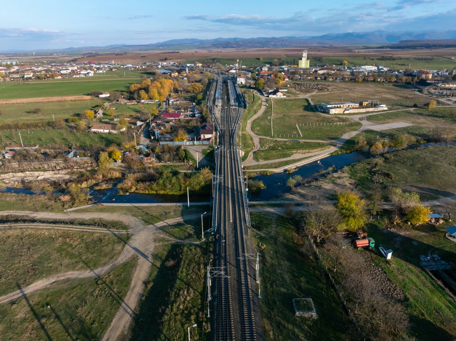 Aerial view of railway tracks branching across open countryside