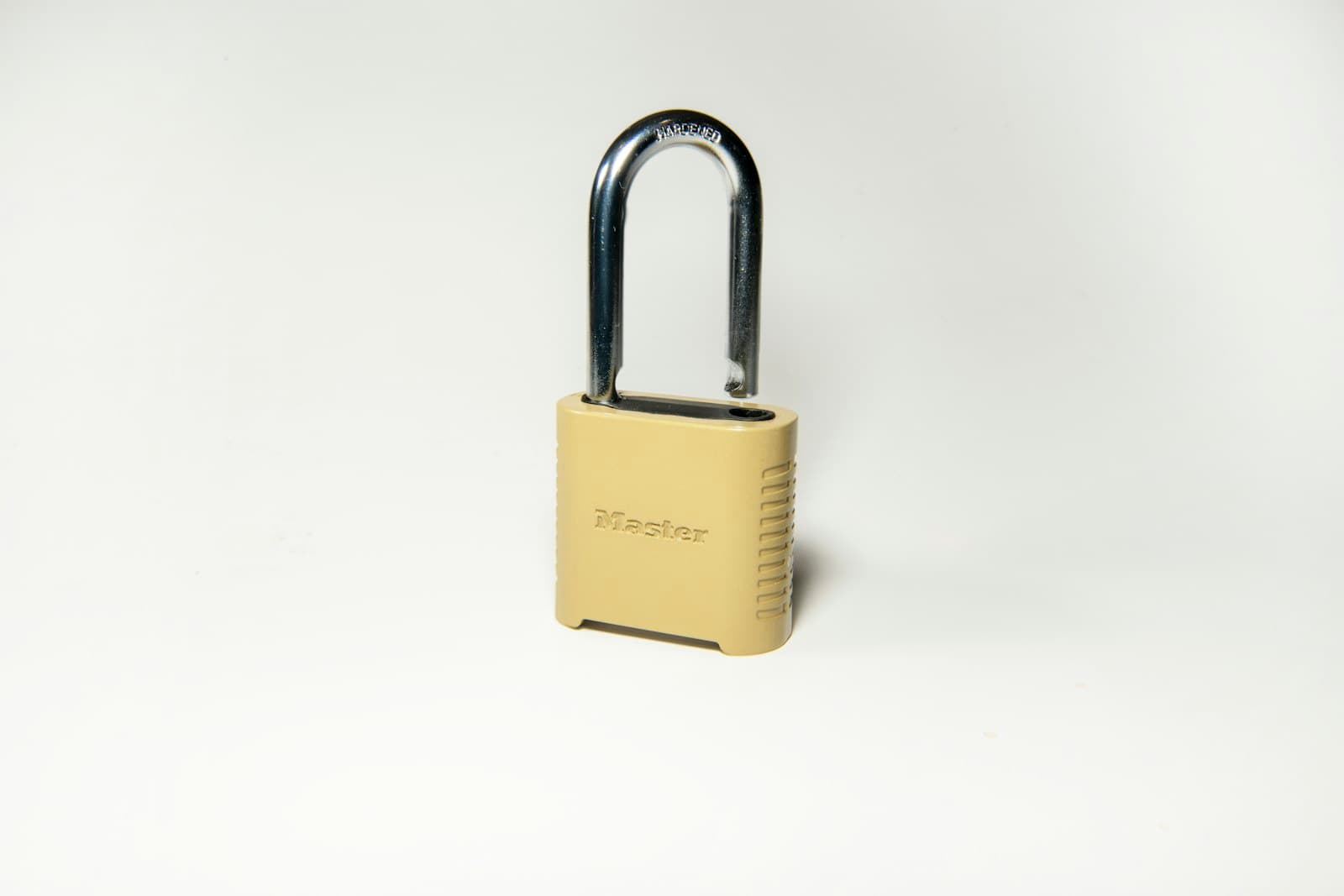 Brass padlock on a white surface